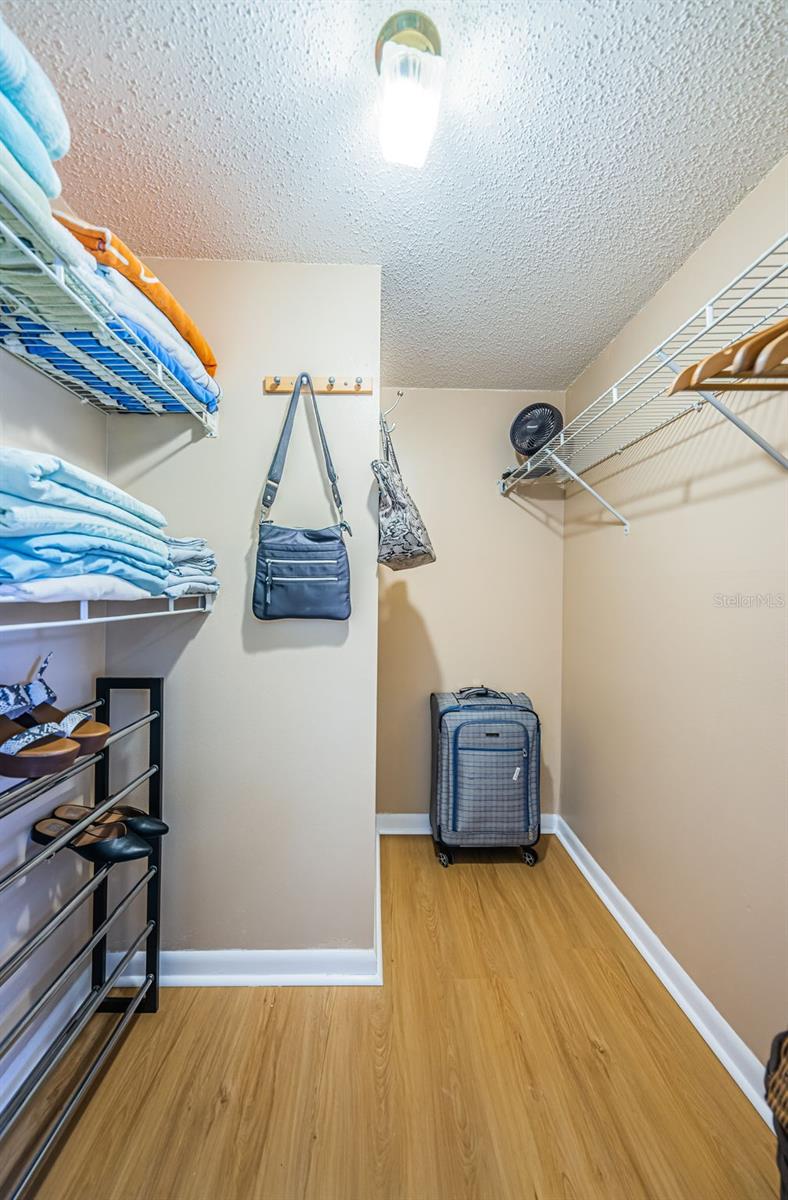 Primary bedroom walk-in closet