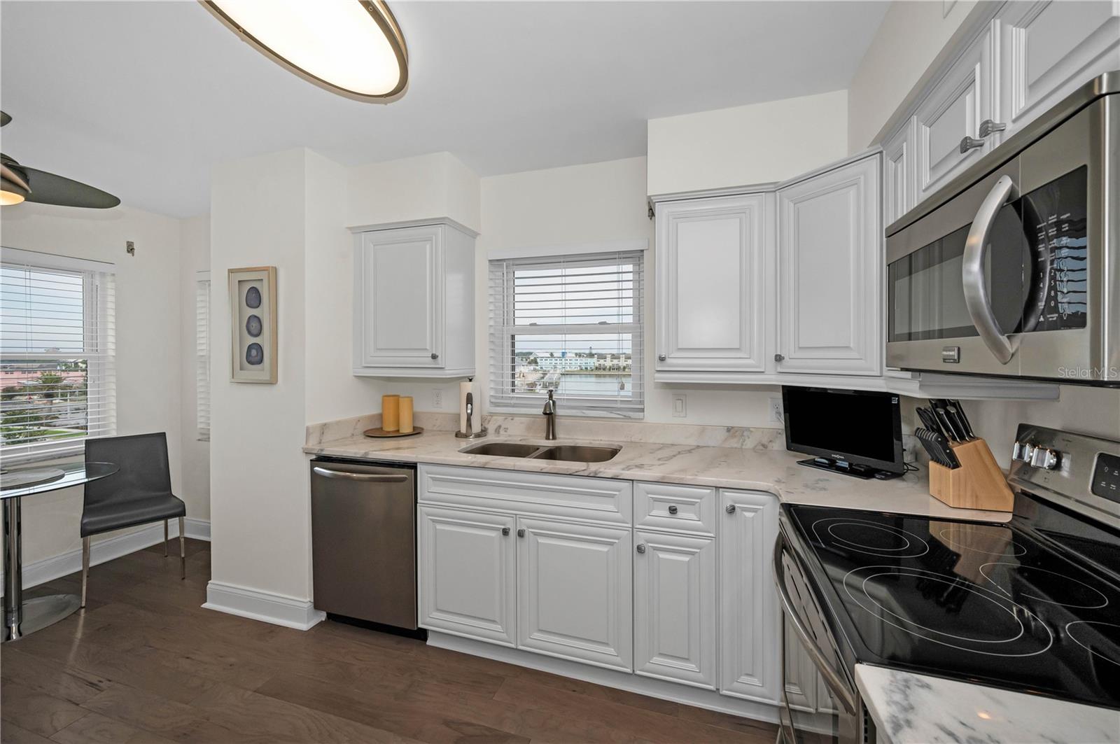 Beautiful new kitchen with solid wood cabinets, newer appliances, and solid wood flooring!