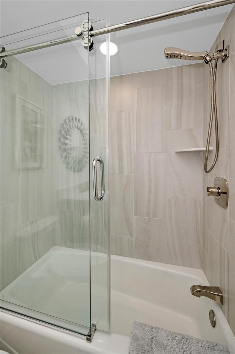 Second Bathroom tub and shower with touch rollers for easy opening and shutting of your glass doors.  Special designer gold overhead handheld and wall and tub attachments.  Overhead natural light fixture.