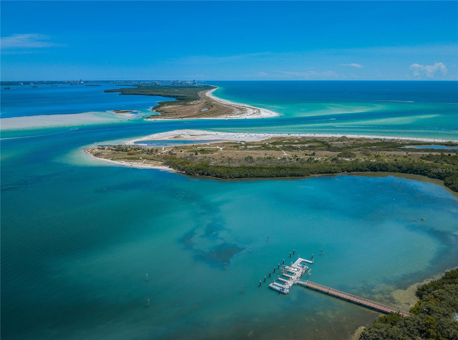 Aerial view of Honeymoon Island and Caladesi Island.  Strip between two islands is called Hurricane Pass, made by natural causes from a hurricane in 1921 that separated the two islands.  Take Ferry Boat to Caladesi, the Ferry will pull into a Marina and drop you off.  There is a little store for hot dogs etc and you can go right over the sand dunes out to to the most gorgeous beach!