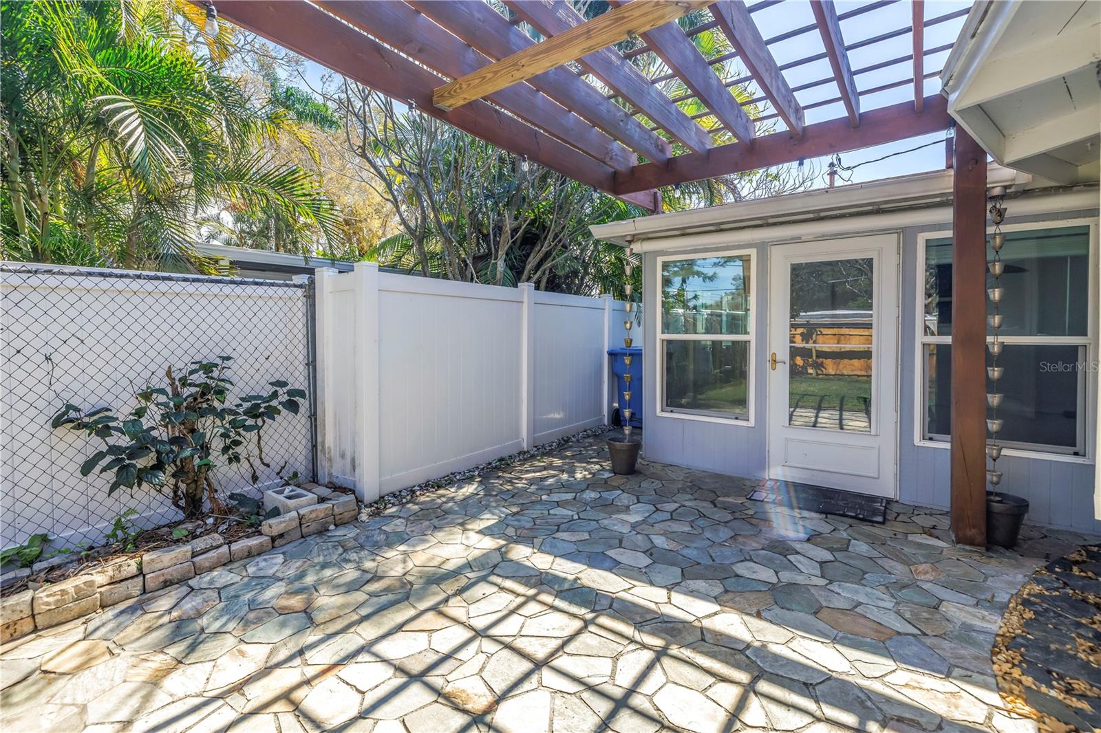 Adorable back patio with a pergola.