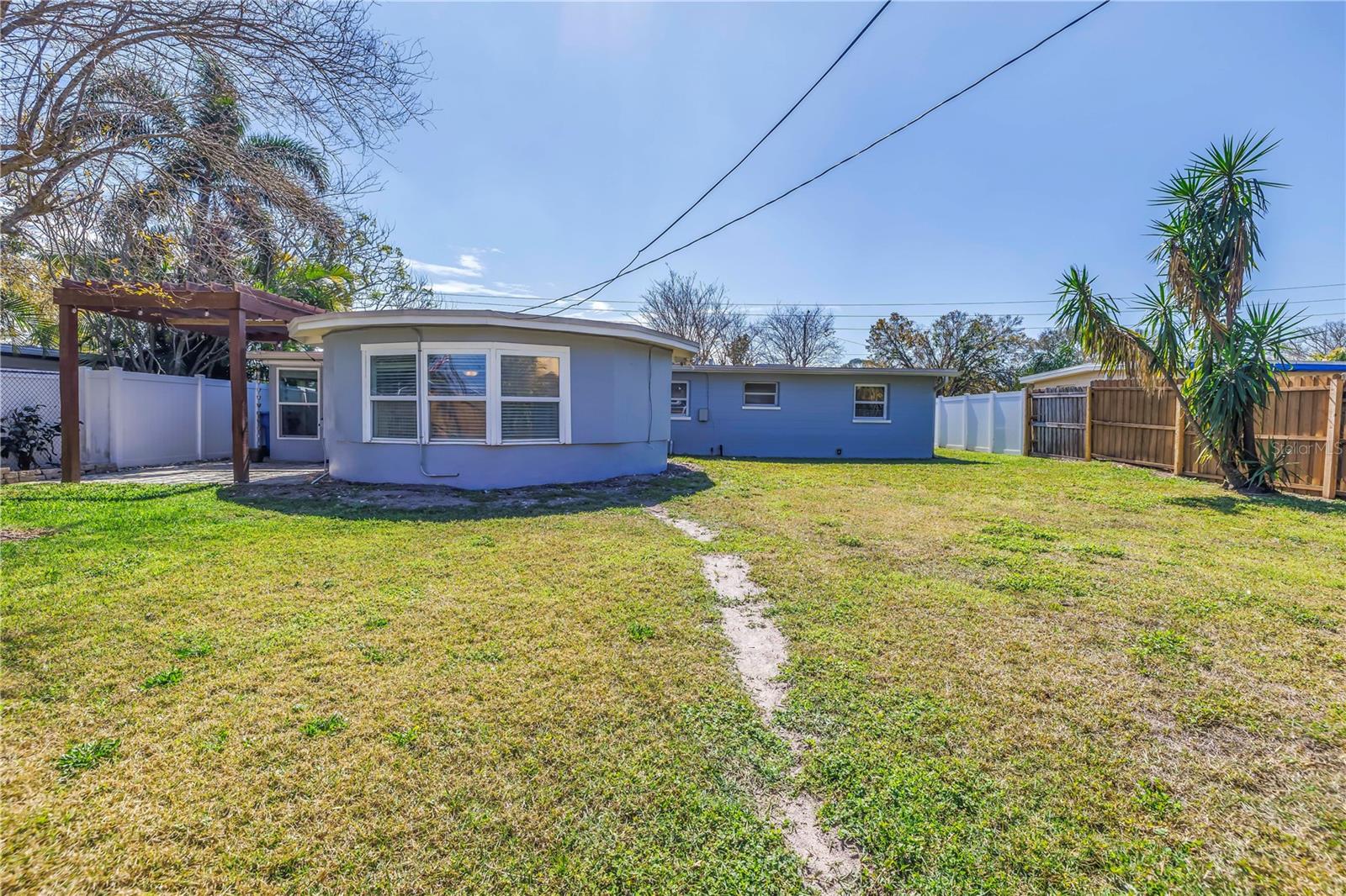 Spacious back yard offers a new French drain system.