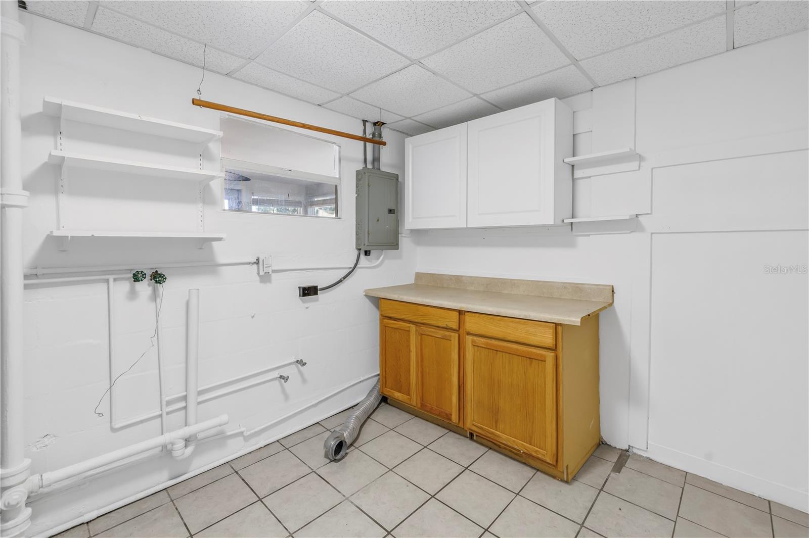 Laundry room with additional storage space. Can be converted into a 2nd bathroom.