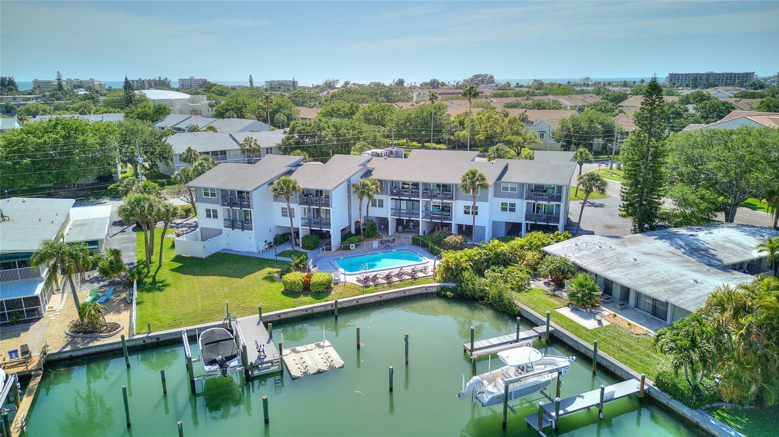 View of the building, pool and 2 docks (on the left side of picture)