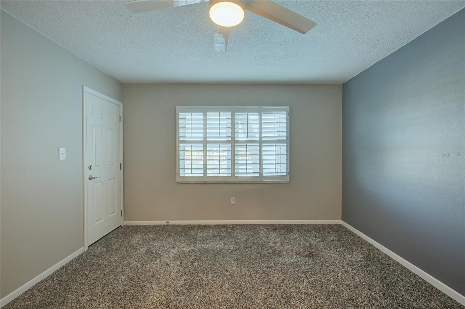 Primary bedroom with door to balcony