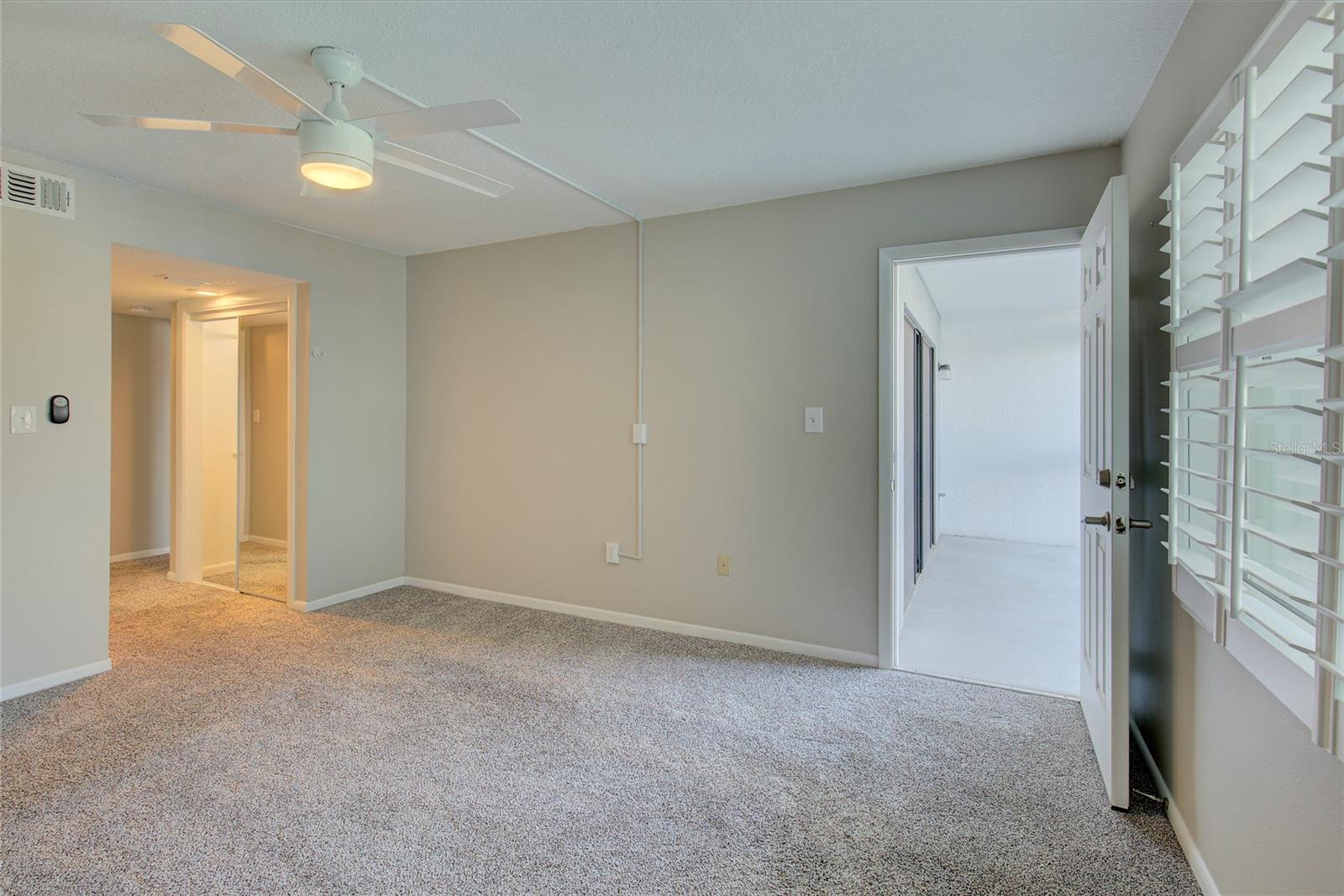 Primary bedroom with door to balcony