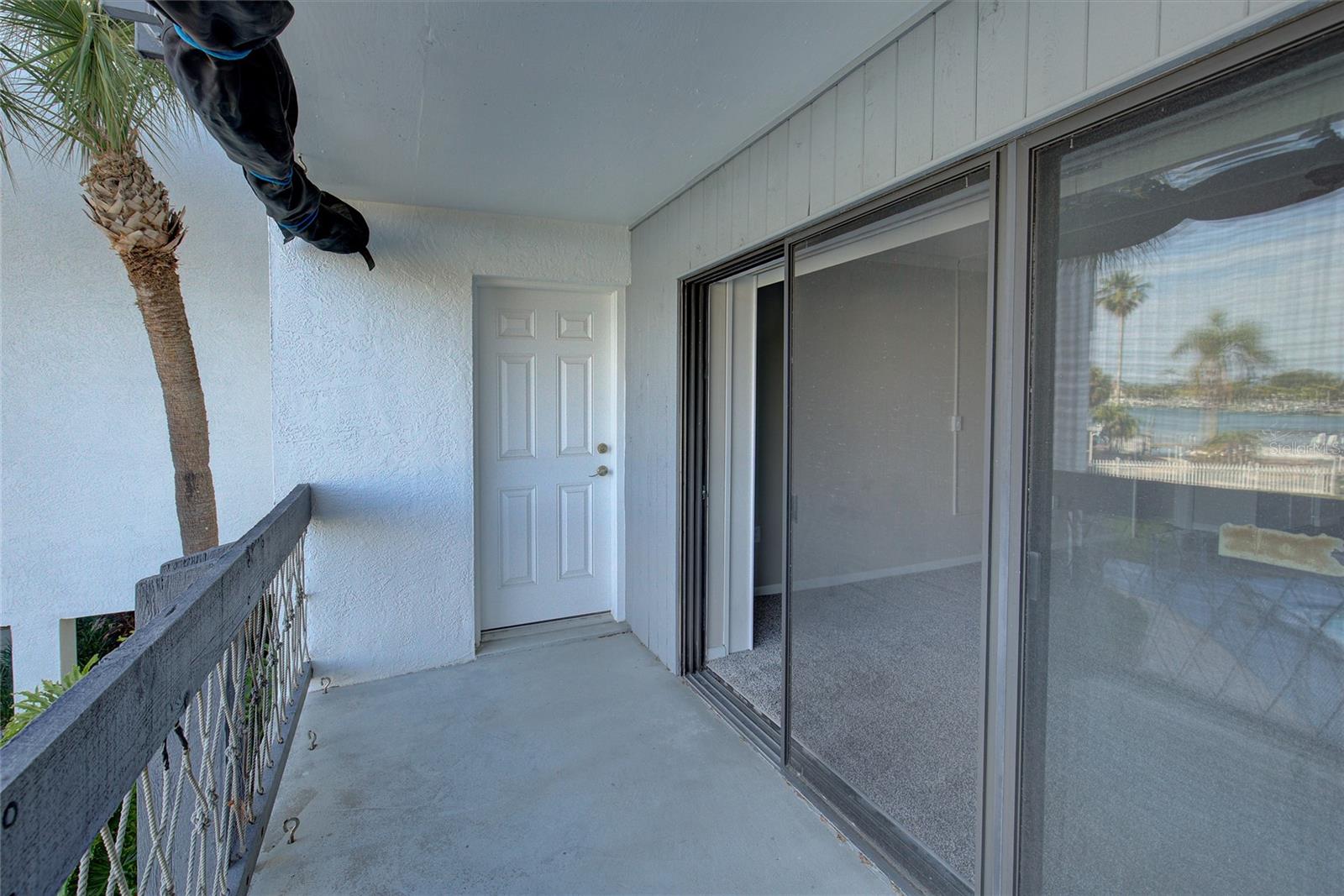 Balcony with door to primary bedroom and sliding doors to living room