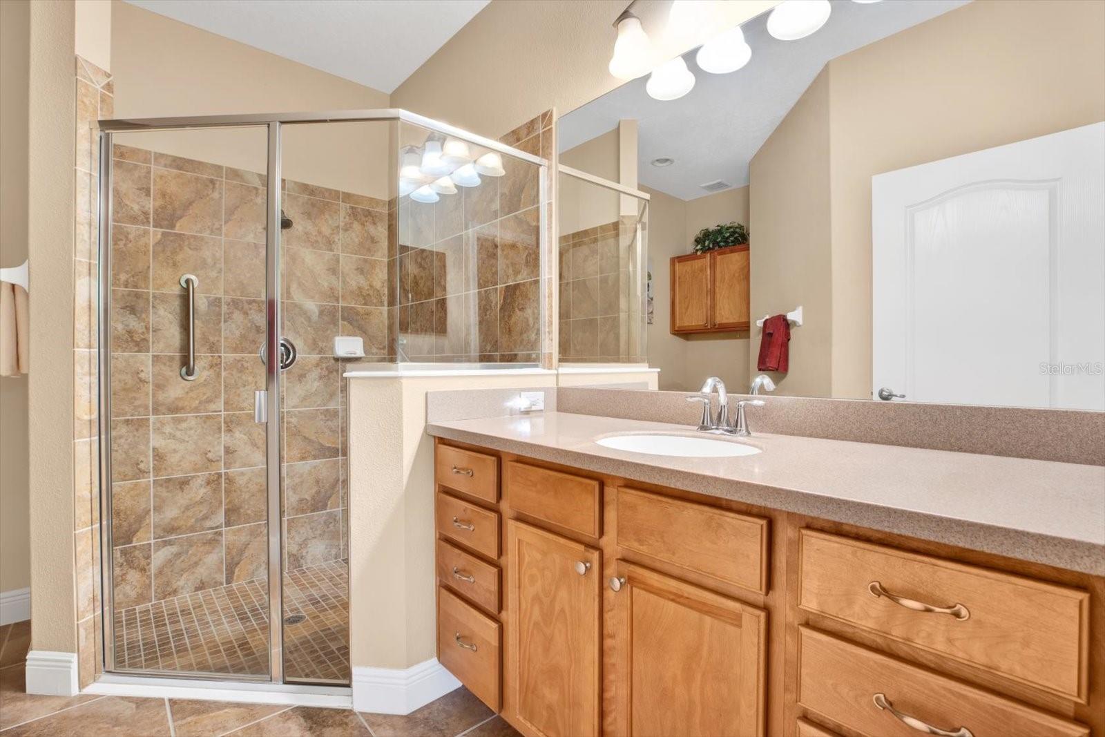 Primary bath has a shower with grab bar,