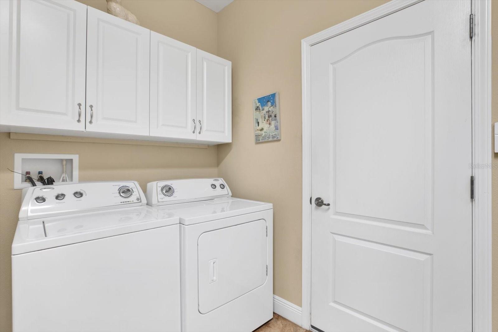 Inside laundry, Storage cabinets plus a large storage closet.