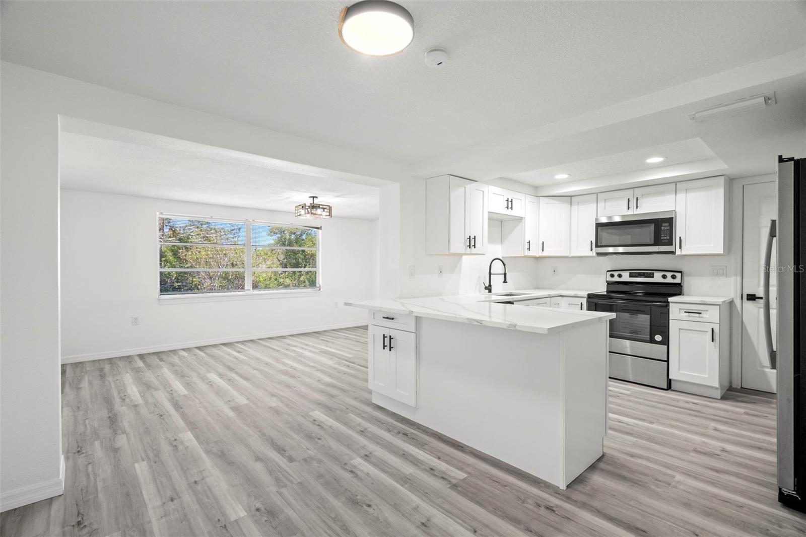 living room area with view of kitchen