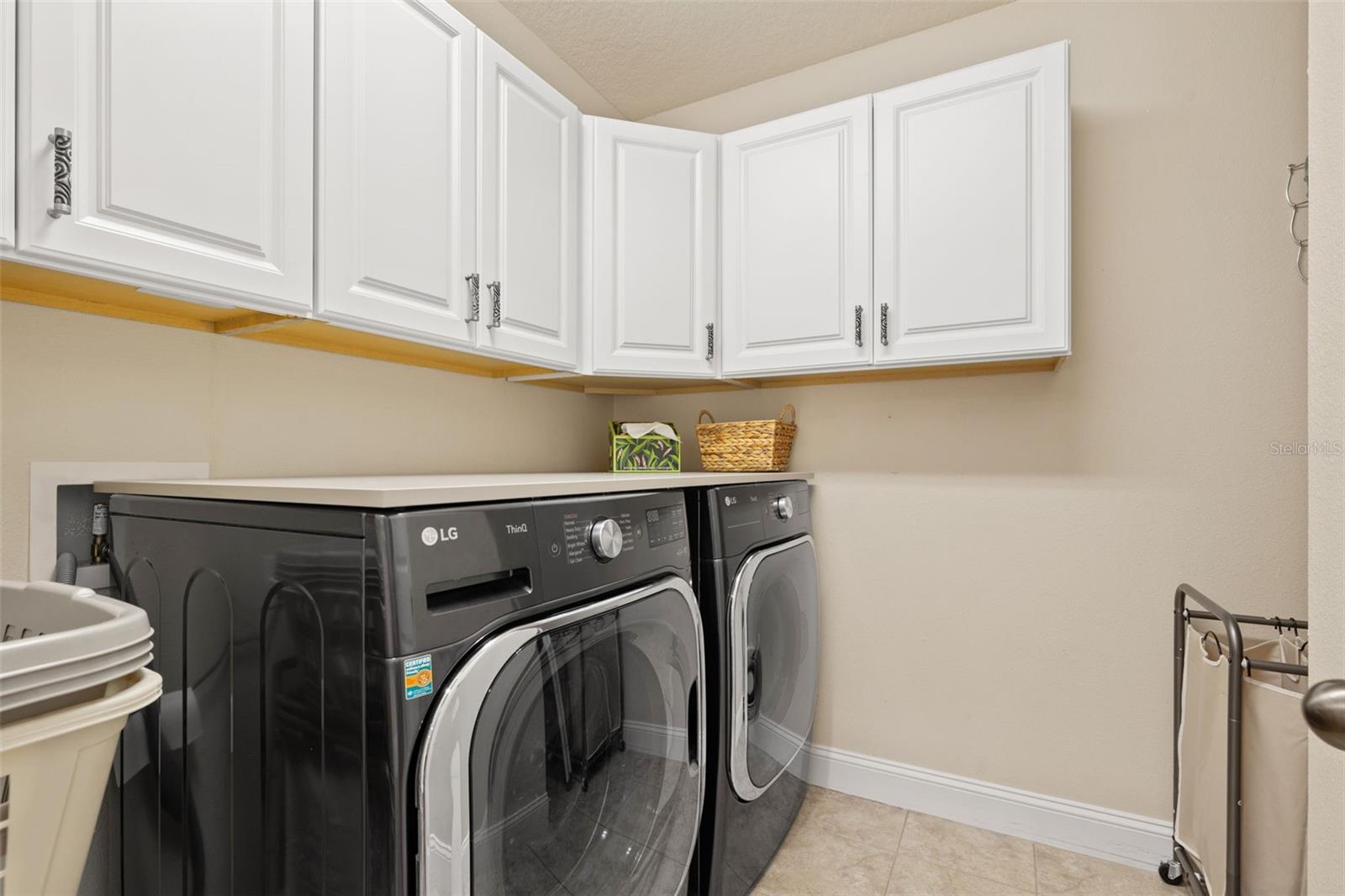 Spacious laundry room with sink and cabinets