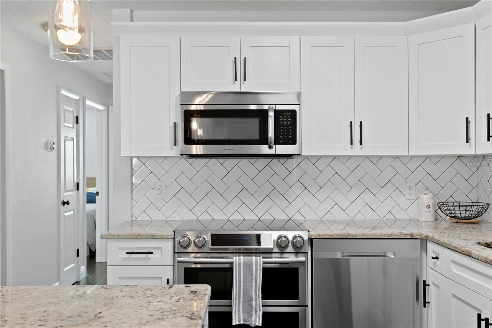 Kitchen leading to the pantry, linen closet, and secondary bedrooms, and bath