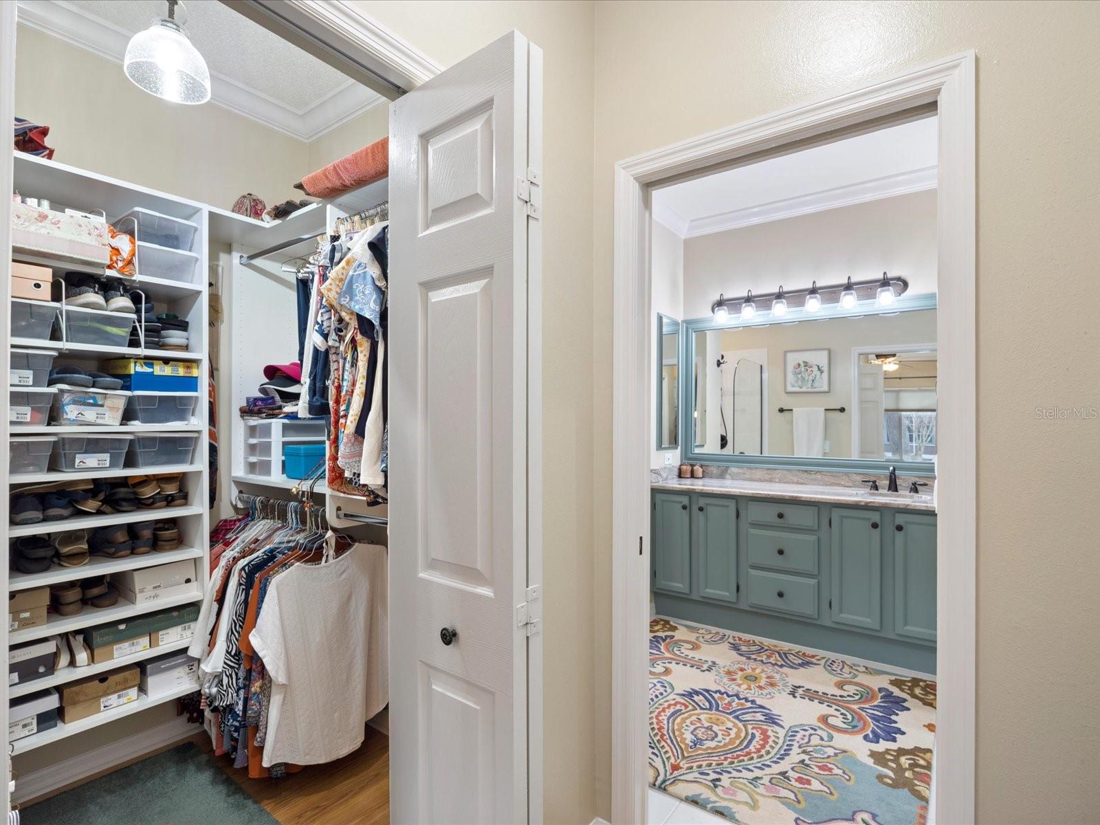 Walk in closet and wall closet between primary bed and bath