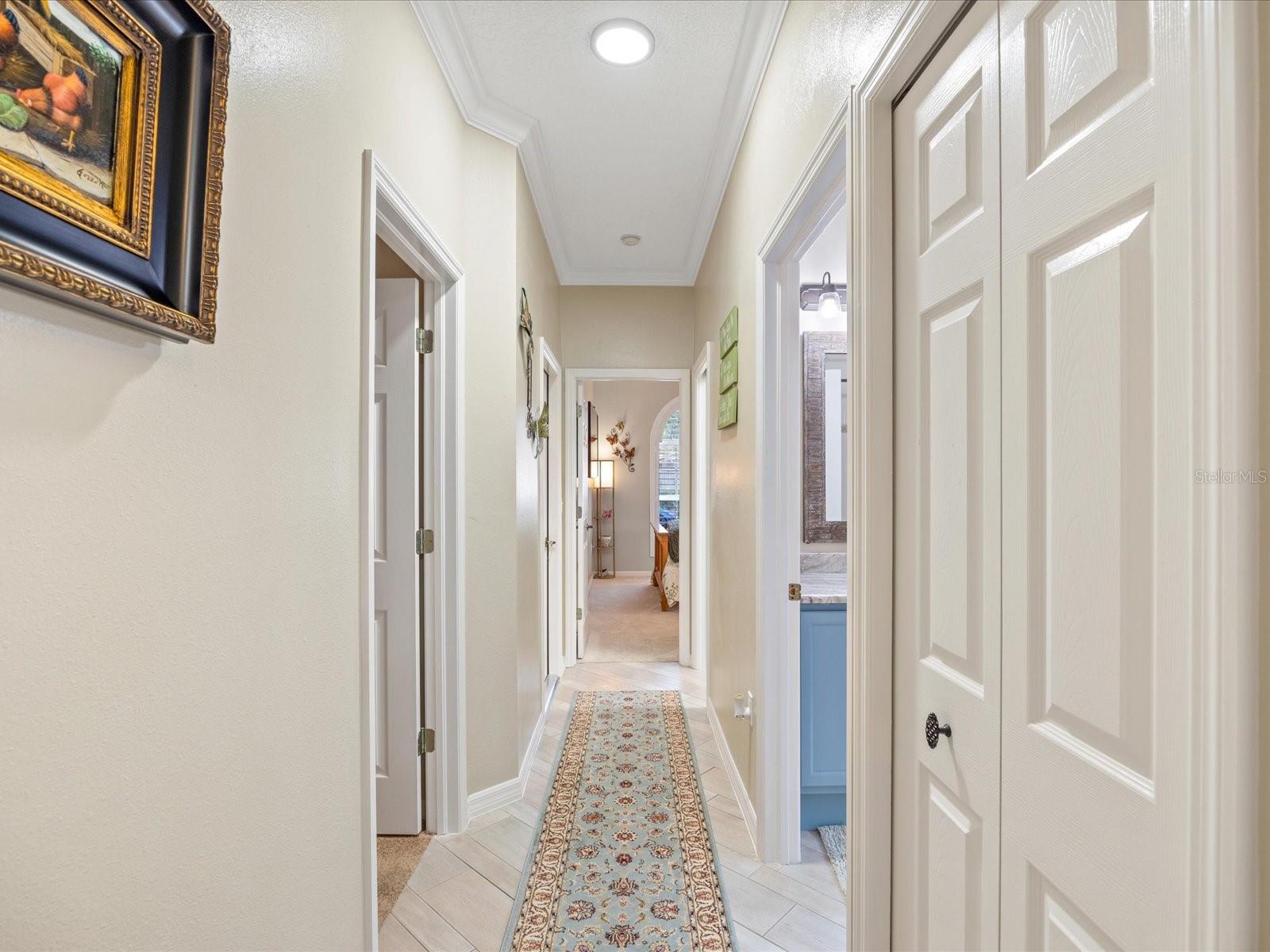 Hallway to additional bedrooms, bath, garage and indoor laundry