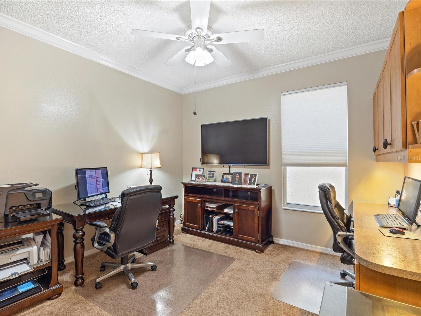 2nd bedroom with built in desk and overhead cabinets