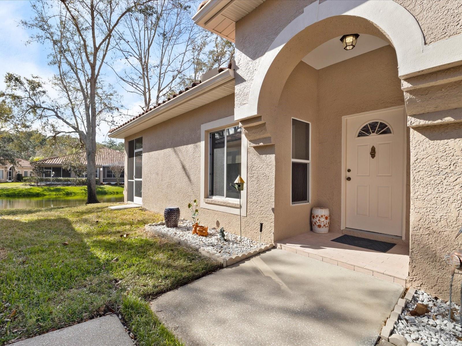 Side entrance with sidewalk to doorway