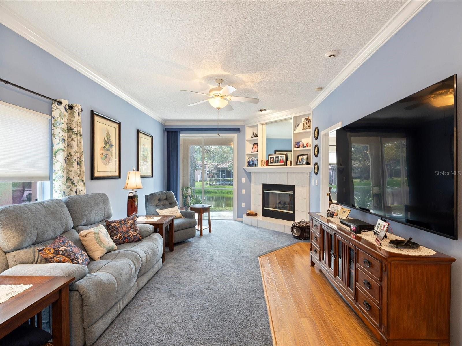 Living room with fireplace and sliders to lanai