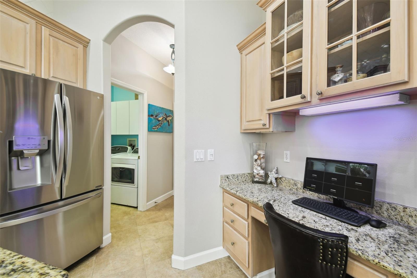 Secretary space with glass cabinetry above