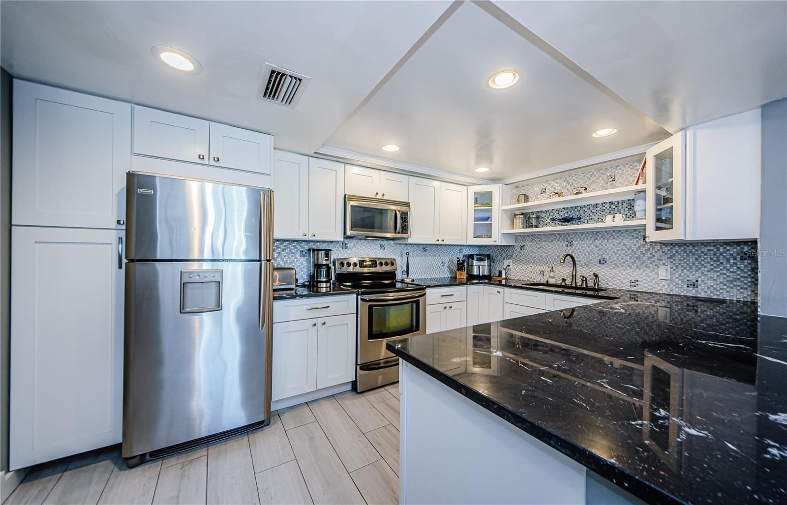 This updated kitchen with the large island is great for casual dining!  That's what you do at the beach!