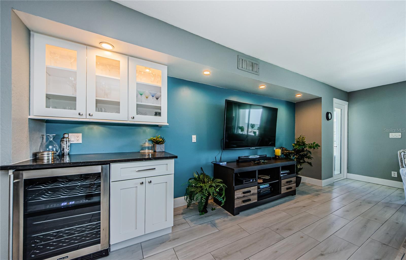 Built in beverage cooler and dry bar in the living room.  The door to the right leads to the large balcony!