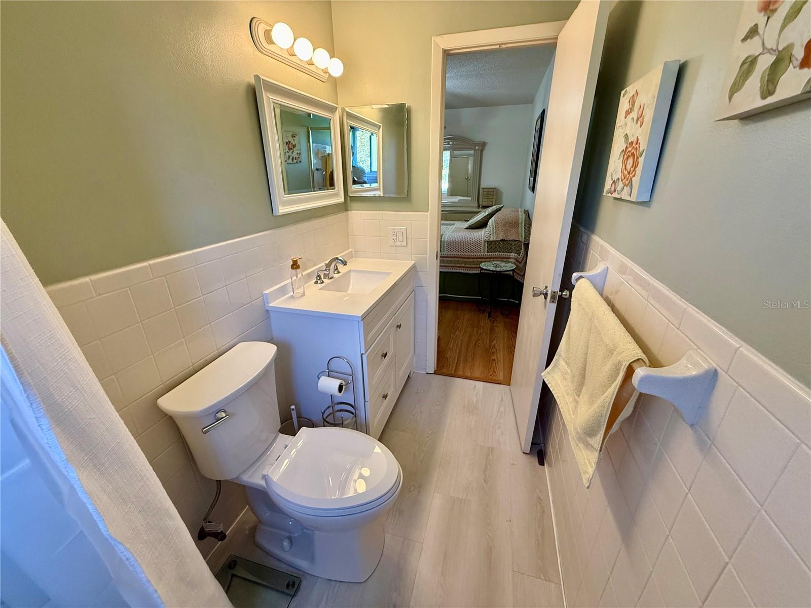 Newer vanity, toilet and vinyl flooring