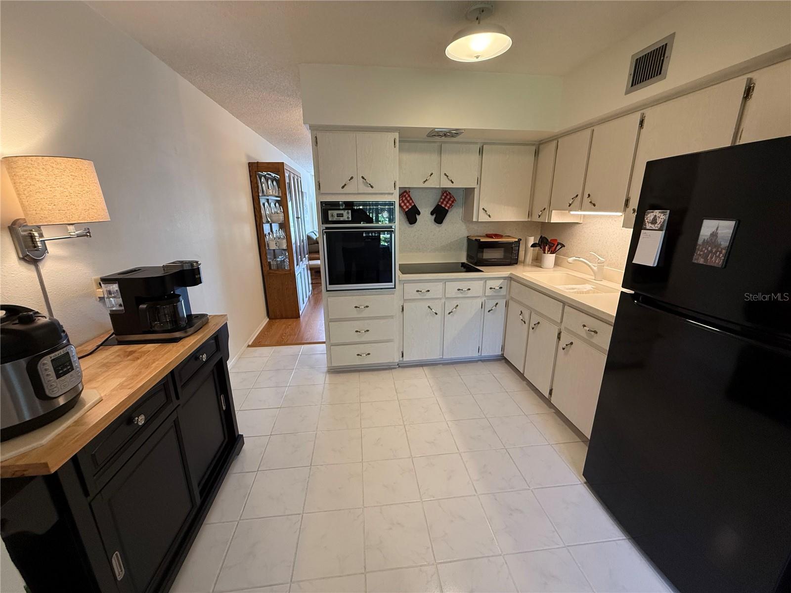 Clean light and bright ample size kitchen with buffet table