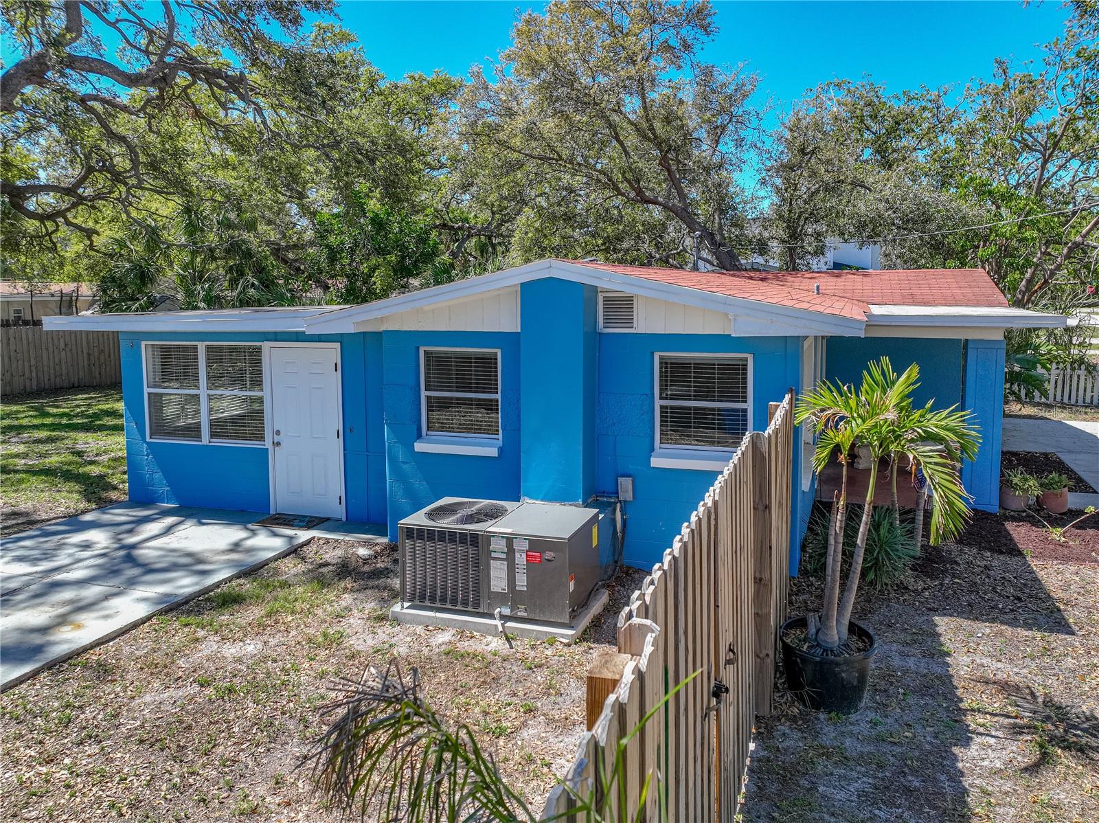 Large, fenced back yard with dual gates that open to allow access for a boat or RV vehicle.