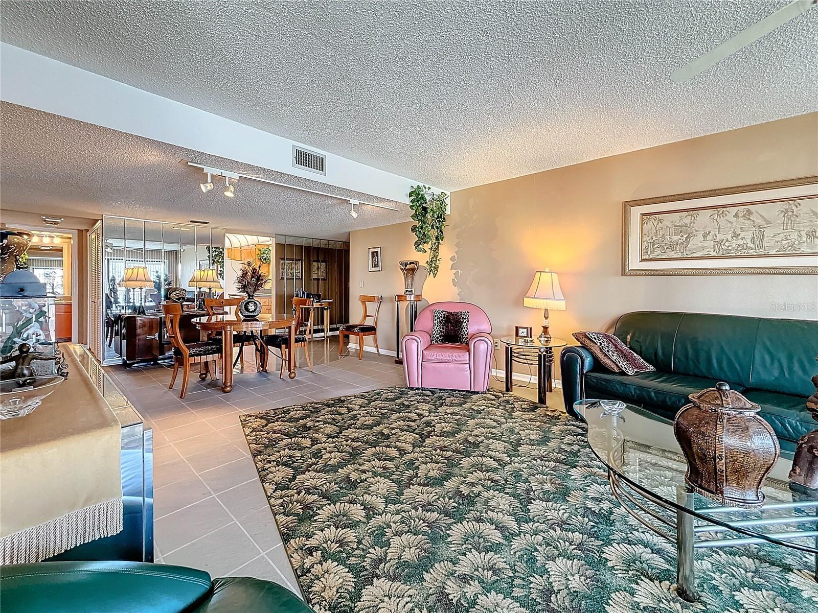 This spacious living & dining area offers an inviting open-concept layout filled with natural light.