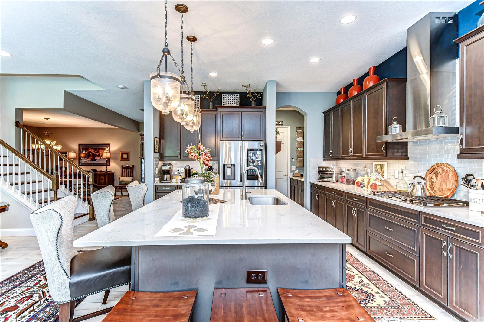 This stunning kitchen features a spacious island, chic pendant lighting, and sleek cabinetry.