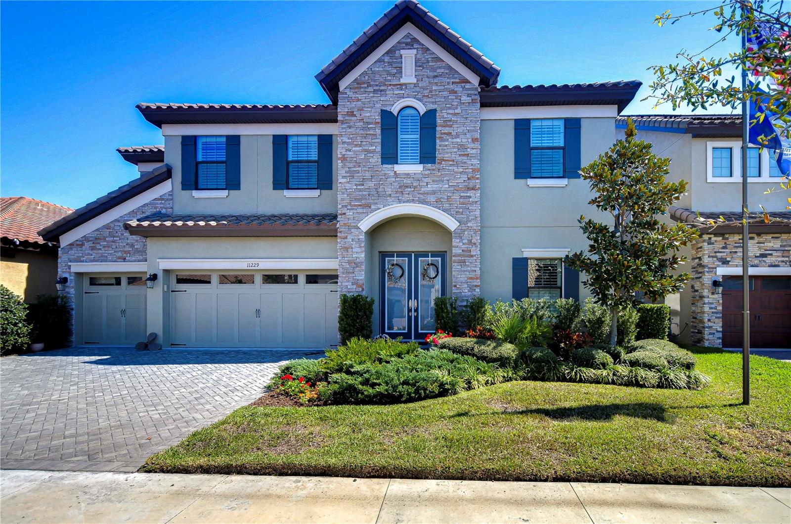 Discover charm in this stunning six-bedroom home featuring a beautiful stone façade and classic tile roof.