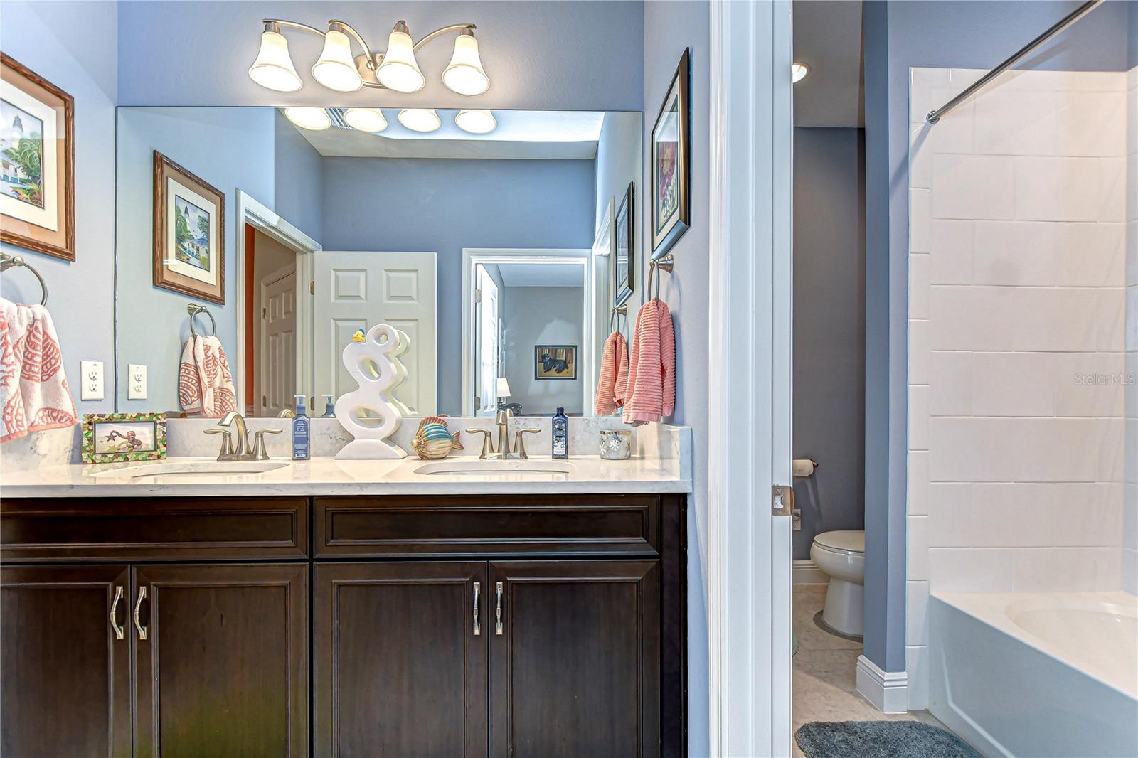 Elegant double vanities in this stylish bathroom provide the perfect setting for a morning routine