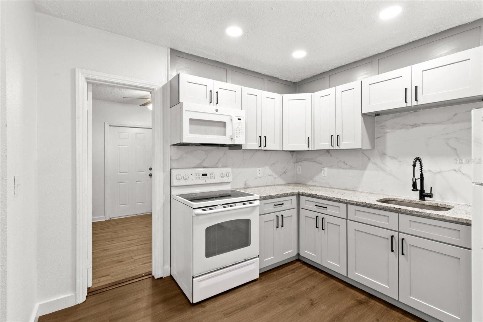 L Shaped Kitchen w/ New White Shaker Cabinets & Granite Countertops