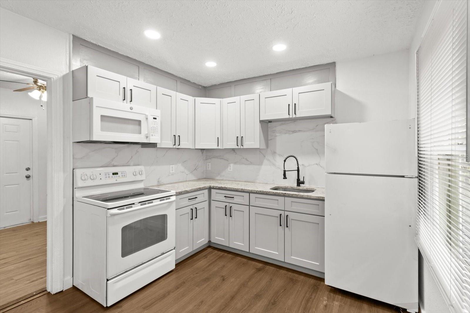 L Shaped Kitchen w/ NEW: White Shaker Cabinets, Granite Countertops & "Marble Style" Tile Backsplash... Newer Appliances