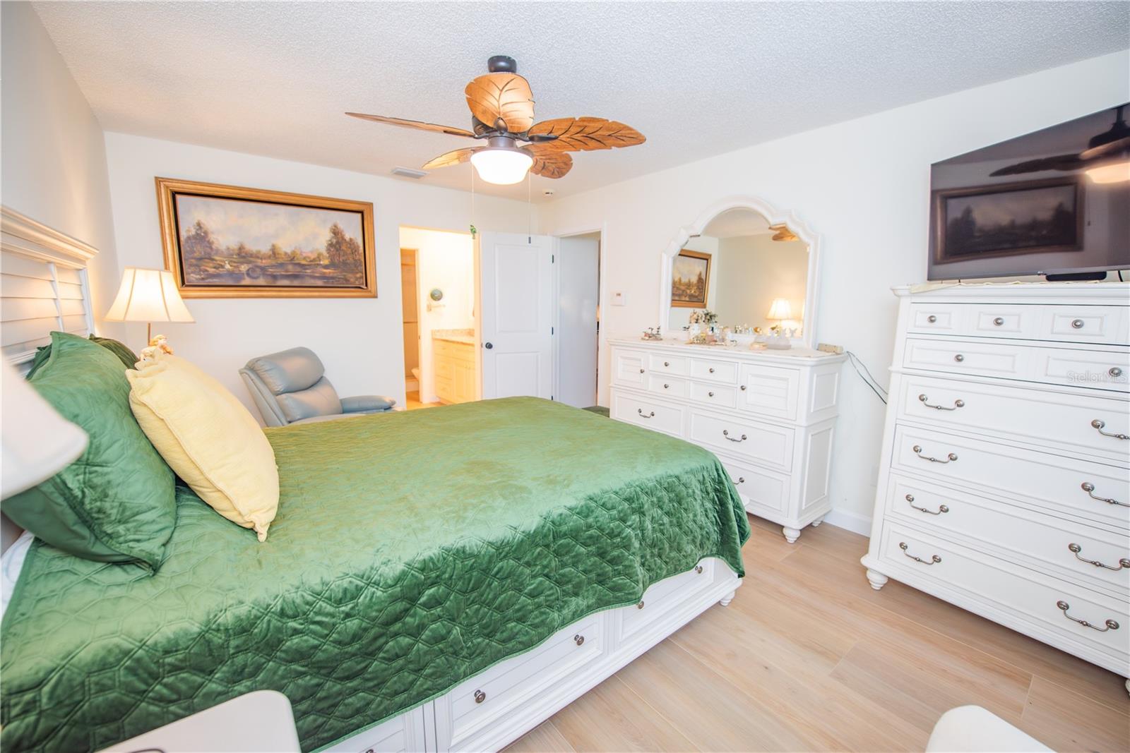 NICE FLOORS AND FAN IN PRIMARY BEDROOM.