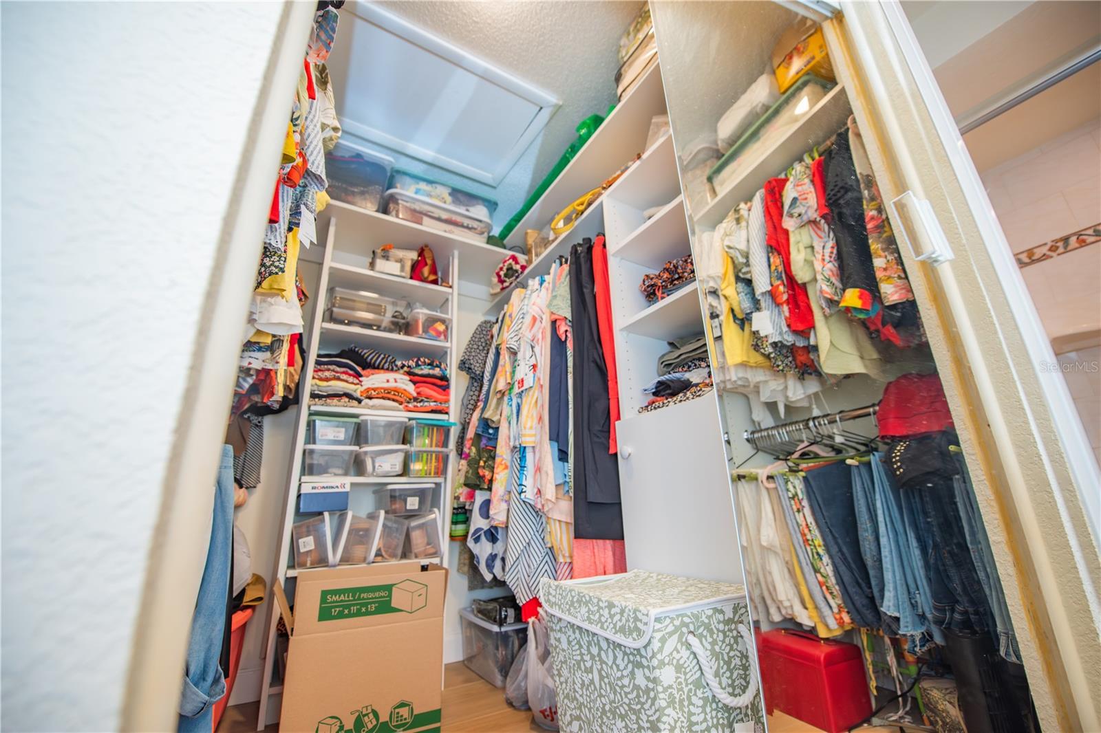 PRIMARY WALK-IN CLOSET HAS CLOTHES ORGANIZERS