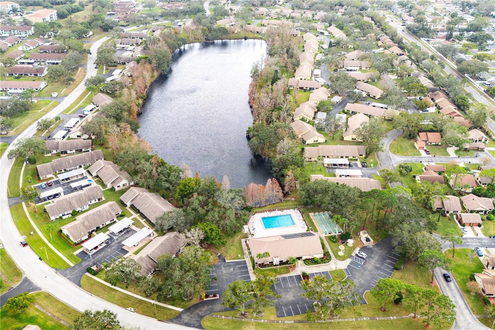 OVERVIEW OF THE CLUBHOUSE, SHUFFLEBOARD AND LAKE IN VILLAGE ON THE GREEN.