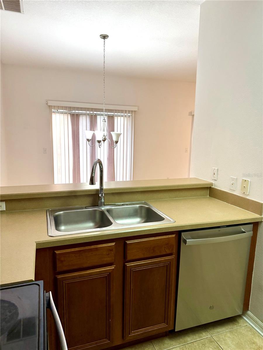 Brand-New Dishwasher and Faucet in the Kitchen with Food Passing Window