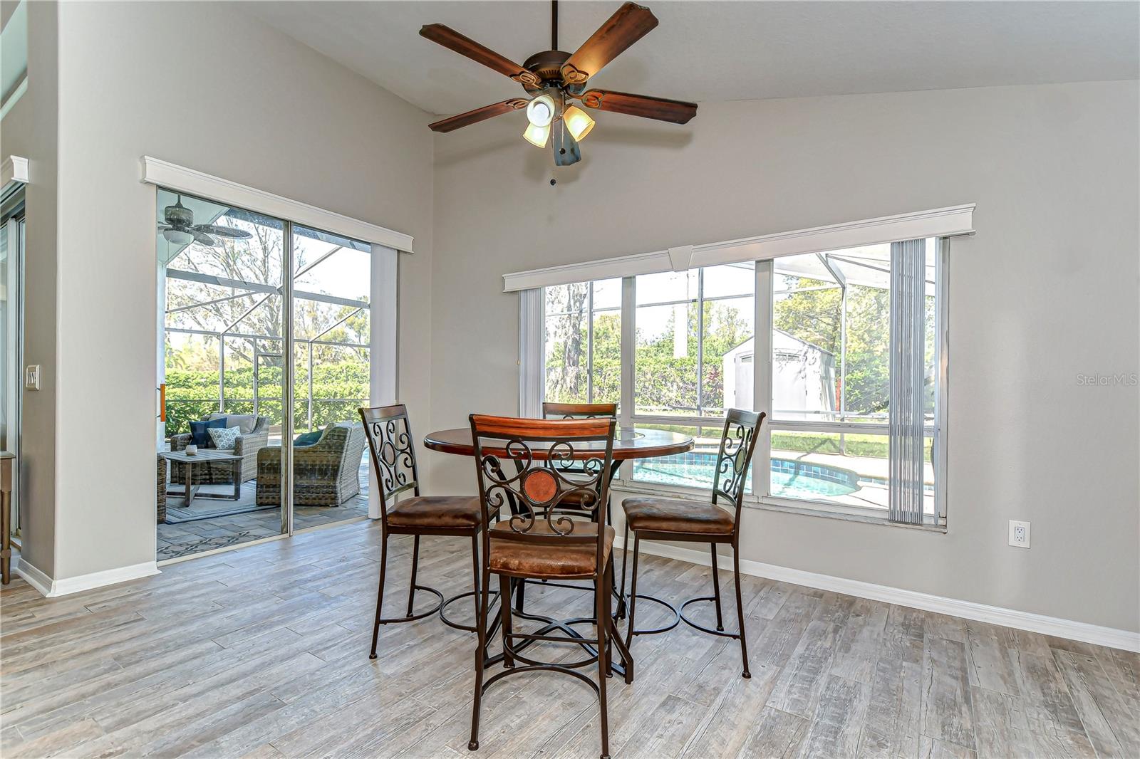 Enjoy your morning coffee in this sunlit dining nook, complete with charming views of the pool and garden.