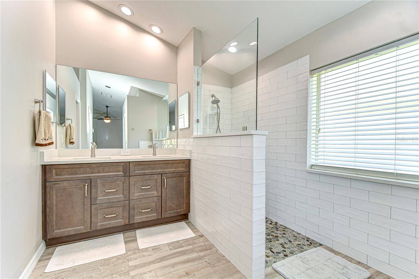 Step into serenity with this elegant bathroom, featuring a sleek double vanity and a luxurious shower