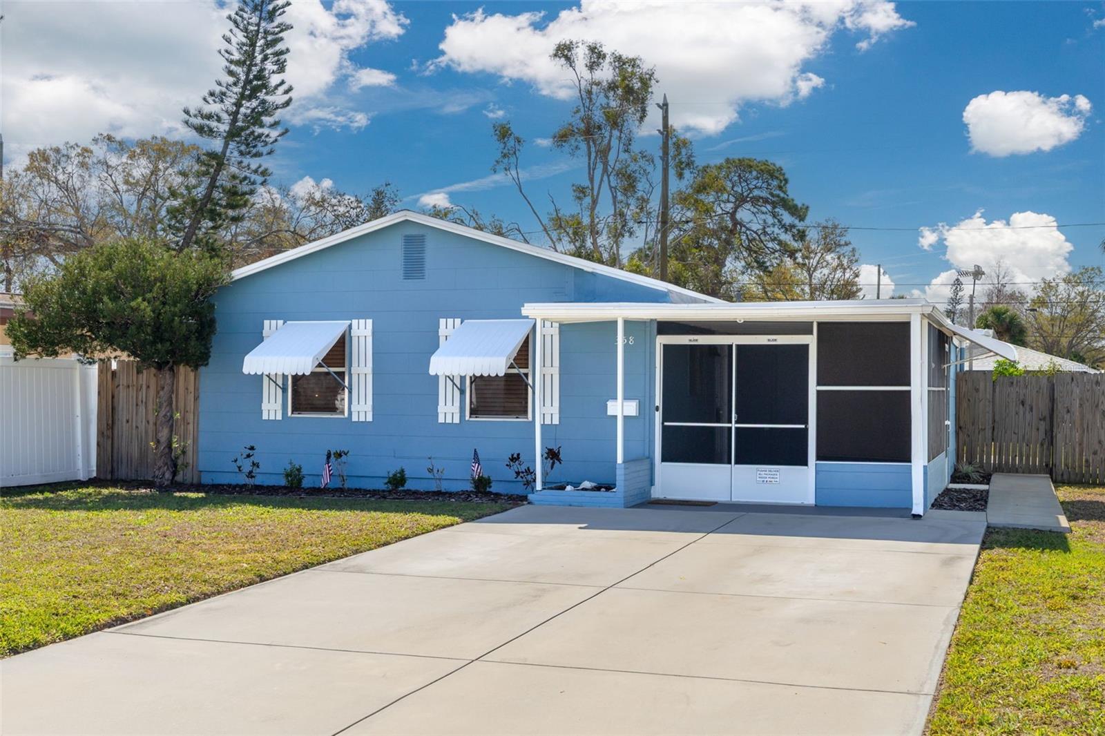 Oversized driveway leads to the screened porch