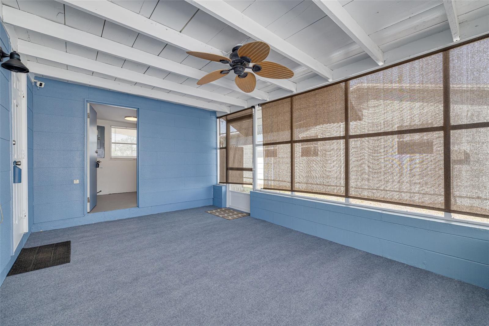 Screened in porch with a laundry room and backyard access