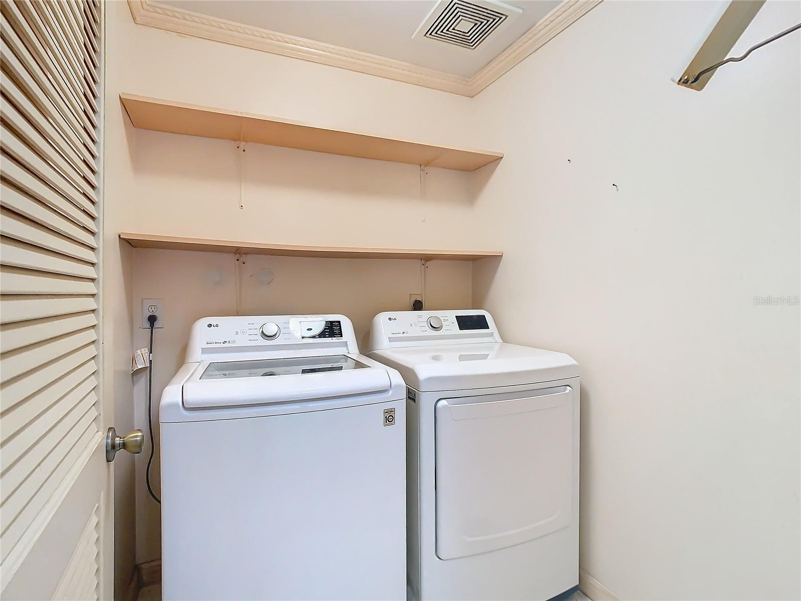 Laundry room with built in shelving for storage