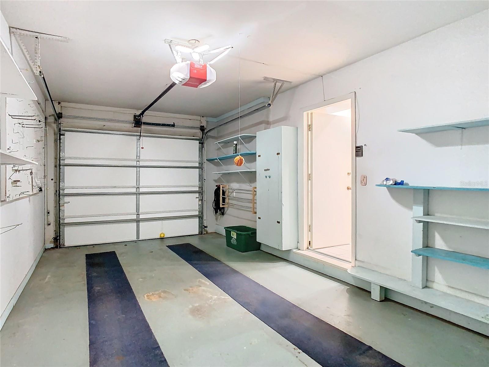 Attached garage with built in shelving for storage