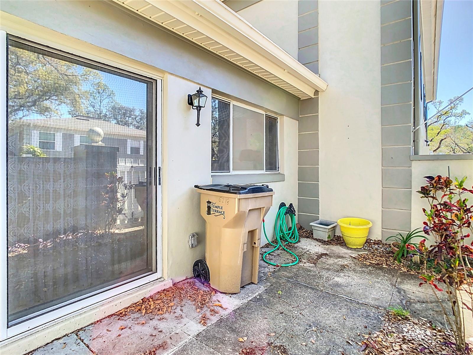 Courtyard view of sliding door leading into dining room