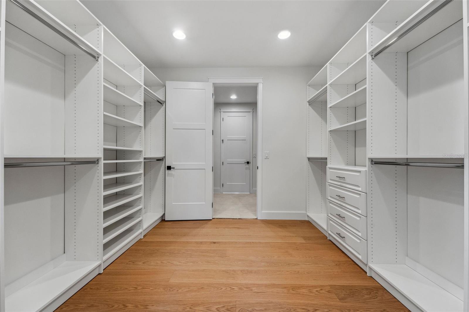 Owners closet with entry to laundry room too