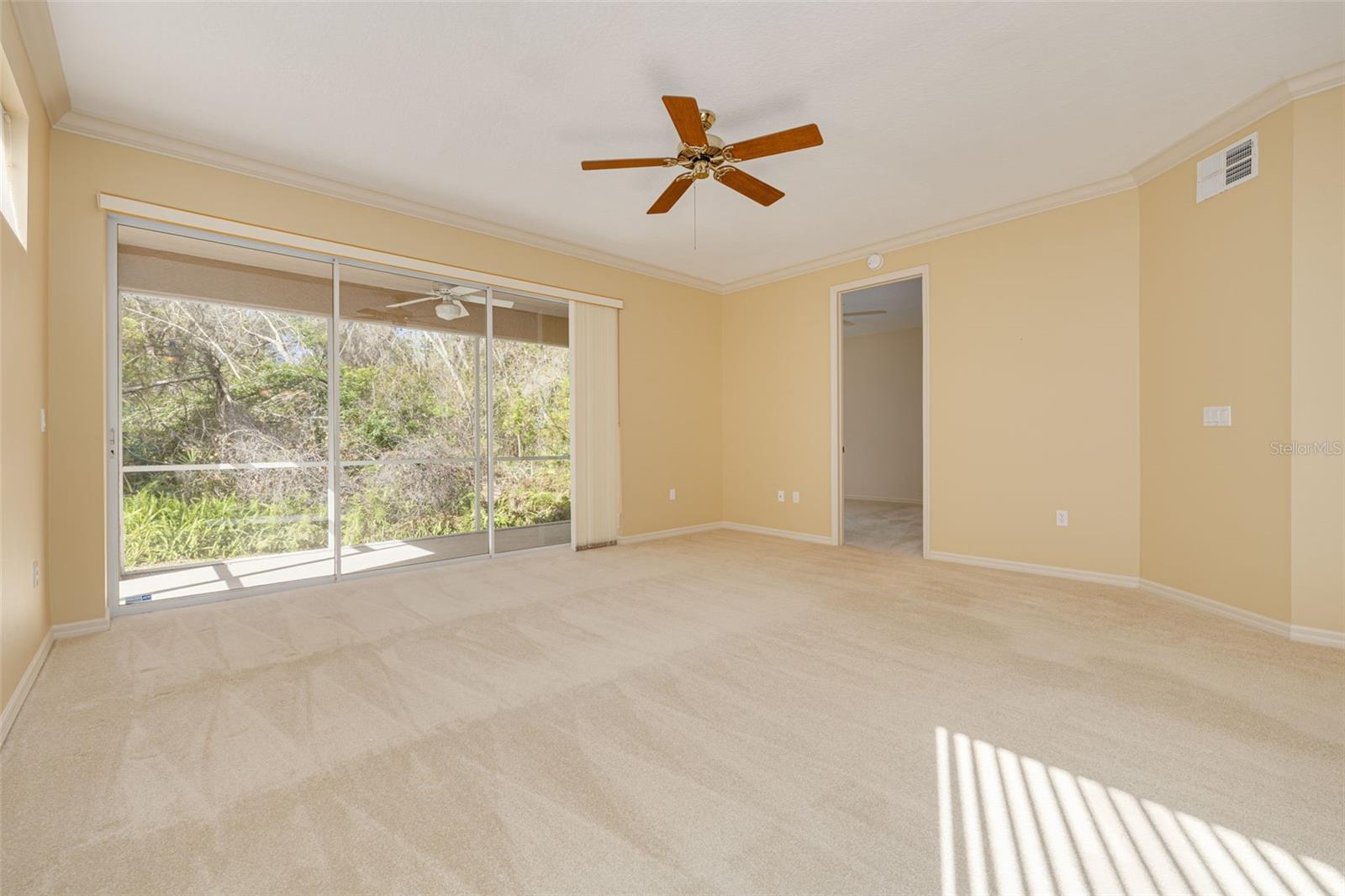 Living room has 3-panel sliders to lanai that overlooks conservation!