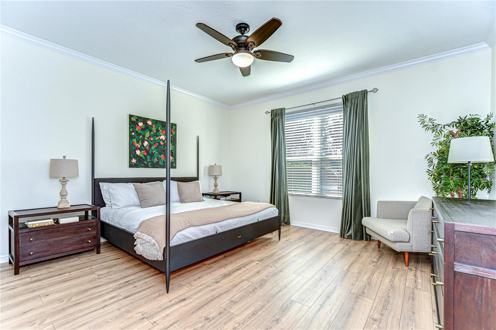 Retreat to the serene primary bedroom featuring sleek floors bathed abundant natural light.