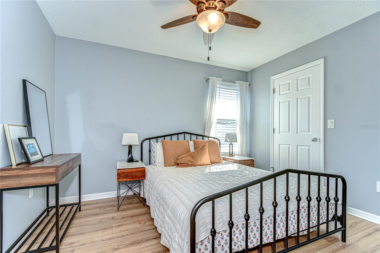 Charming second bedroom bathed in natural light, perfect for relaxation.