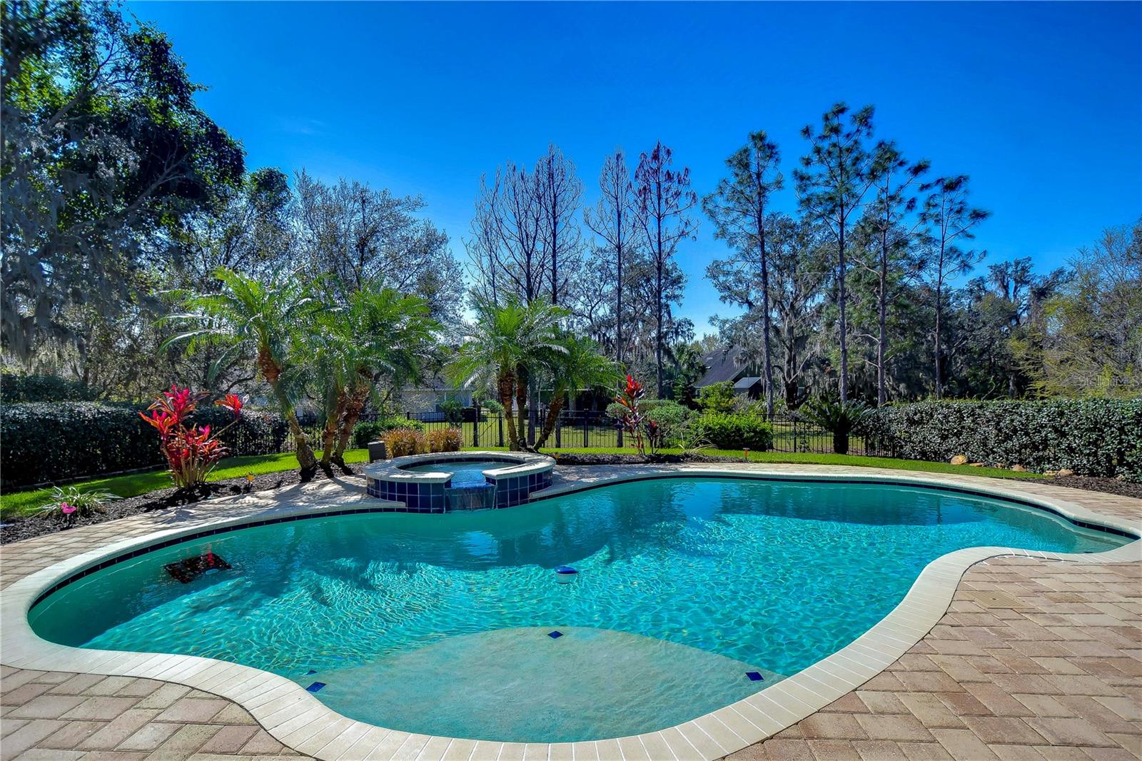 Enjoy the sparkling pool and lush landscaping, offering the perfect escape right at home.