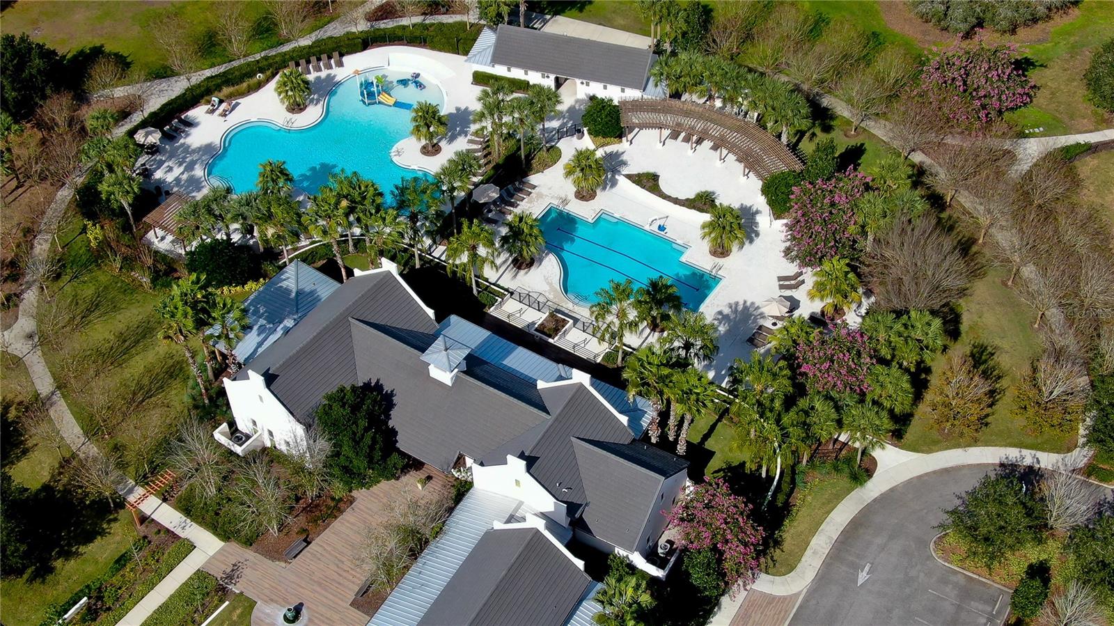 Dive into luxury with this exquisite community featuring two stunning pools surrounded by lush greenery